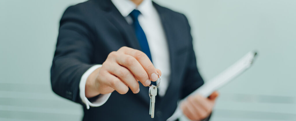 Property manager agent holding keys. Concept for real estate, renting property.